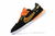 Chuteira Nike Streetgato Futsal em preto e laranja e a sola branca.