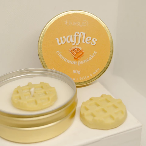 Vela aromática WAFFLES de cinnamon pancakes, na lata dourada e um pequeno waffle decorativo ao lado.