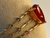 PULSEIRA DOURADA COM PEDRA RUBI E DETALHES EM CRISTAIS COLORIDOS na internet