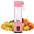 Mini liquidificador portátil rosa com 6 lâminas, rodeado por diversas frutas e sucos.