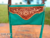 Bolsa transversal verde em couro legítimo, com detalhe floral na parte frontal, e franjas.
