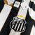 Camisa do Santos Futebol Clube com o escudo bordado e detalhes em dourado.