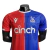 Camisa Crystal Palace I 23/24 - Jogador Macron Masculina - Vermelha e azul com detalhes em branco na internet