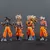 Conjunto de 4 figuras de ação Dragon Ball Son Goku Super Saiyan, detalhadas e coloridas, ideal para colecionadores, decoração e fãs do anime.