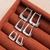 Trio de Brincos de Argolas Articuladas Quadradas Cravejadas com Zircônias Banhados em Ródio Branco - comprar online