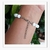 Pulseira Branca Pingente Metal - comprar online