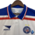 Camisa retrô do EC Bahia, modelo 98/99, predominantemente branca com detalhes em azul e vermelho.