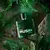 Frasco de colônia Musk+ 75ml da Avon, rodeado por folhas verdes e pedras.