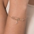 552176 - Pulseira Rommanel folheada a ouro porque Ele vive e cruz com zircônias na internet