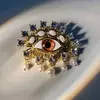 Broche Olho com pérolas