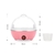 Panela elétrica para cozinhar ovos na cor rosa, com tampa transparente e recipiente para água ao lado.