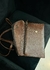 Bolso café convencional con cierre, mostrando su diseño y textura de piel.