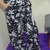 Calça pantalona estampada em preto e branco com estampa floral e animal, com bolsos nas laterais.