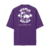 Camiseta oversized roxa com a frase "WORLD SAVIOR" em destaque na parte de trás, com detalhes escrito “JESUS CHRIST IS THE SAVIOR OF THE WORLD”