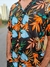 Camisa masculina estampada da marca Lazza. O modelo Brisada é preto com estampa florida azul, laranja, branca e verde.