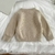 Sweater beige con moños - primeros pasitos