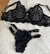 Conjunto de lingerie em tule bordado preto com detalhes em corações, composto por sutiã e calcinha.