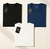 Kit com 3 camisetas básicas masculinas de algodão premium nas cores preta, azul e branca, dobradas com etiquetas da marca Future