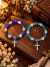 Kit 2 Pulseiras Elásticas Religiosas com Cruz de Strass, Pedras Azuis e Detalhes Dourados
