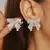 Brincos Laço Strass – Luxo Delicado com Toque Romântico - clickprimer