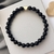 Pulseira Ônix 6mm Coração Dourado na internet