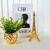 Livro caixa porta objetos, vaso dourado e enfeite torre - comprar online
