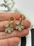 Argola 1,9cm cravejada com flor pendente de 1,5cm banhada a ouro 18k - comprar online
