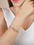MEIO BRACELETE COM TIGRE BANHO OURO 18K CRAV. EM MICRO ZIRCÔNIAS CÚBIC INCOLORES na internet