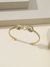 MEIO BRACELETE COM TIGRE BANHO OURO 18K CRAV. EM MICRO ZIRCÔNIAS CÚBIC INCOLORES - Laços de Luz
