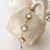 Pulseira trevos madrepérola em aço inoxidável dourado - comprar online