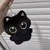 Chaveiro de gato preto com olhos grandes