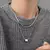 GeoCharm Duo – Colar Feminino Prateado com Design Geométrico e Corrente Dupla Fashion - Chave do Look