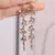 Brinco Elegance Shine – Folha com Borla Longa e Strass