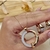 Imagem do Conjunto Colar Pingente Redondo Vazado e Brincos Click Detalhes Cravejados Banhado à Ouro 18k