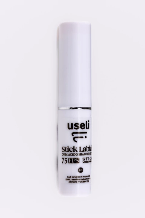 Stick labial Useli em embalagem branca com texto preto, contendo ácido hialurônico e fator de proteção solar FPS 75