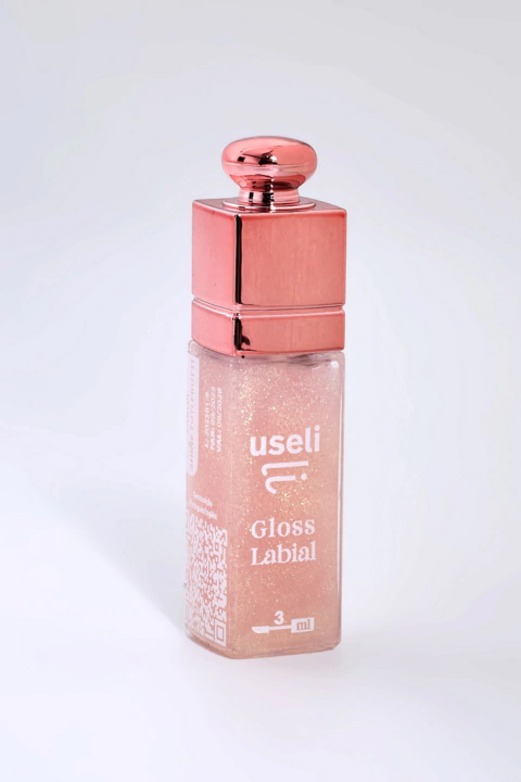 Mini gloss labial Useli Shine Nude com embalagem transparente e tampa rosé metálica