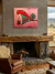 Cuadro moderno con diseño abstracto titulado "EQUILIBRIO" con formas geométricas en tonos rojos y turquesas.