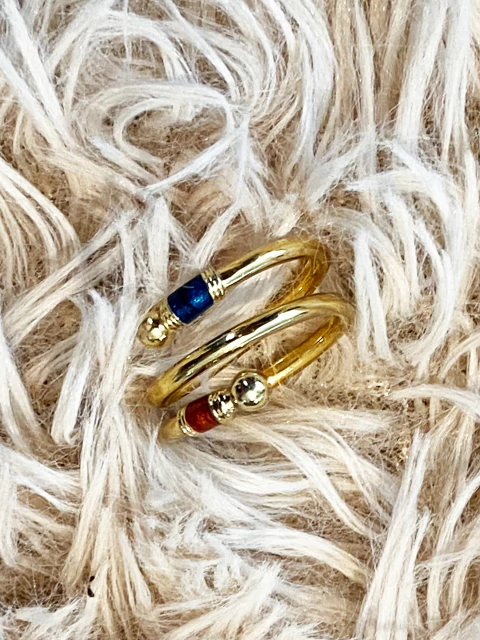 Anel vintage em espiral, com pedrinhas em tons de vinho e azul.