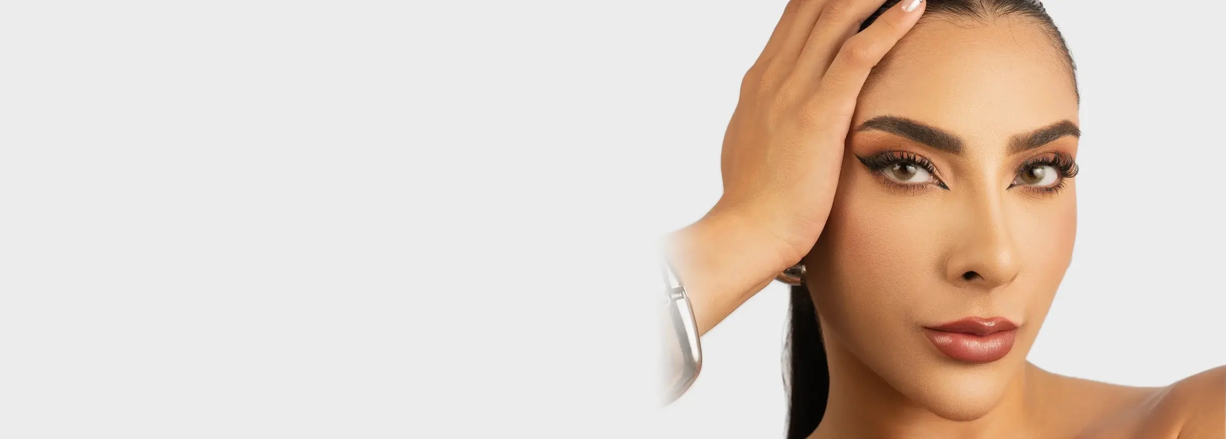 Maíse, fundadora da Cat's Eye, de cabelo preso e mão apoiada na cabeça