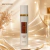 Body Splash Fakhar Isabelle La Belle 300ml em frasco branco com detalhes dourados em fundo bege elegante
