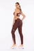 Mulher usando legging marrom escuro da Di Paula Rejane, com detalhes em rosa, detalhes nas costas