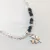 PULSERA REGULABLE CON CRISTALES, BOLITAS Y DIJE CENTRAL TREBOL - comprar online