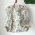 MOCHILA CUADRILLE ROSA Y FLORES en internet