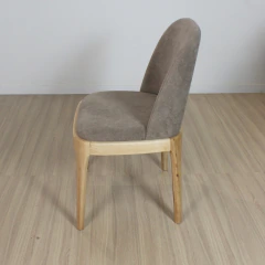Silla moderna con asiento y respaldo tapizados en tela marron y patas de madera clara