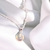 Cadena con anillo tornasolado - Aura