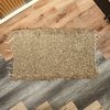 Alfombra beige corta borde tipo algodón 109 x 66 cm