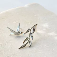 Silver Ornis earrings featuring a bird and a leaf design