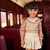 Conjunto Bambollina blusa estampada com renda, saia bege plisada