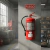 Matafuego ABC de 5kg montado en pared en un taller industrial con señalización de fuego roja